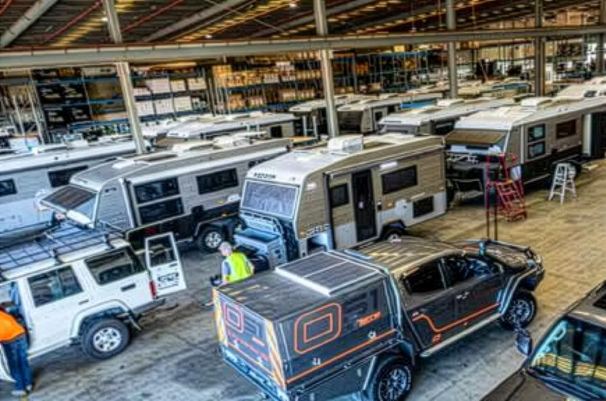 Caravans, trailers and a 4WD inside a manufacturing workshop